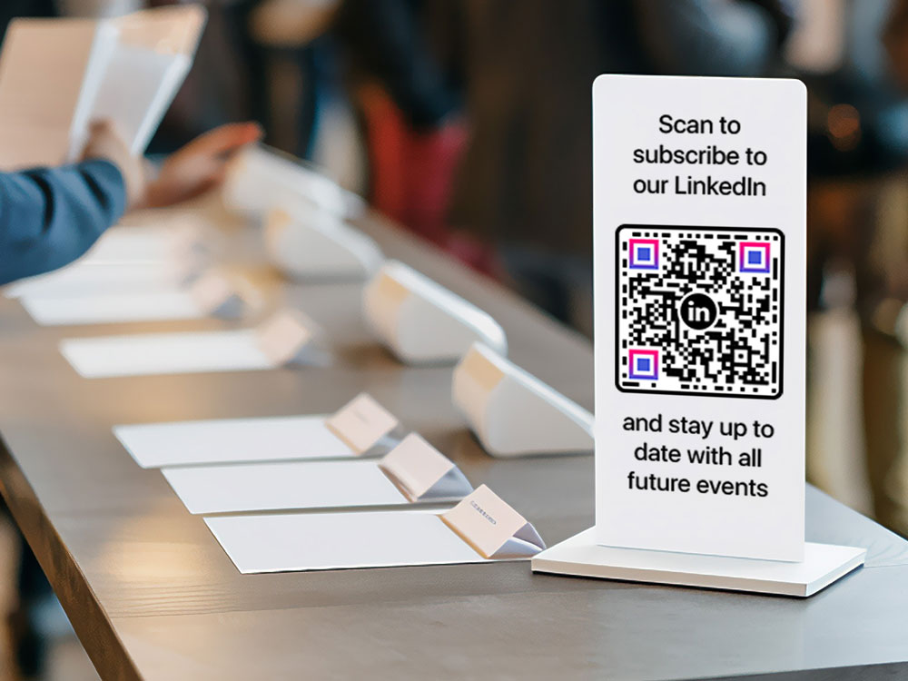 Professional showing LinkedIn QR code at a networking event